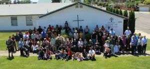 Exterior of the Atwater Church of the Nazarene with group of people gathered in front.