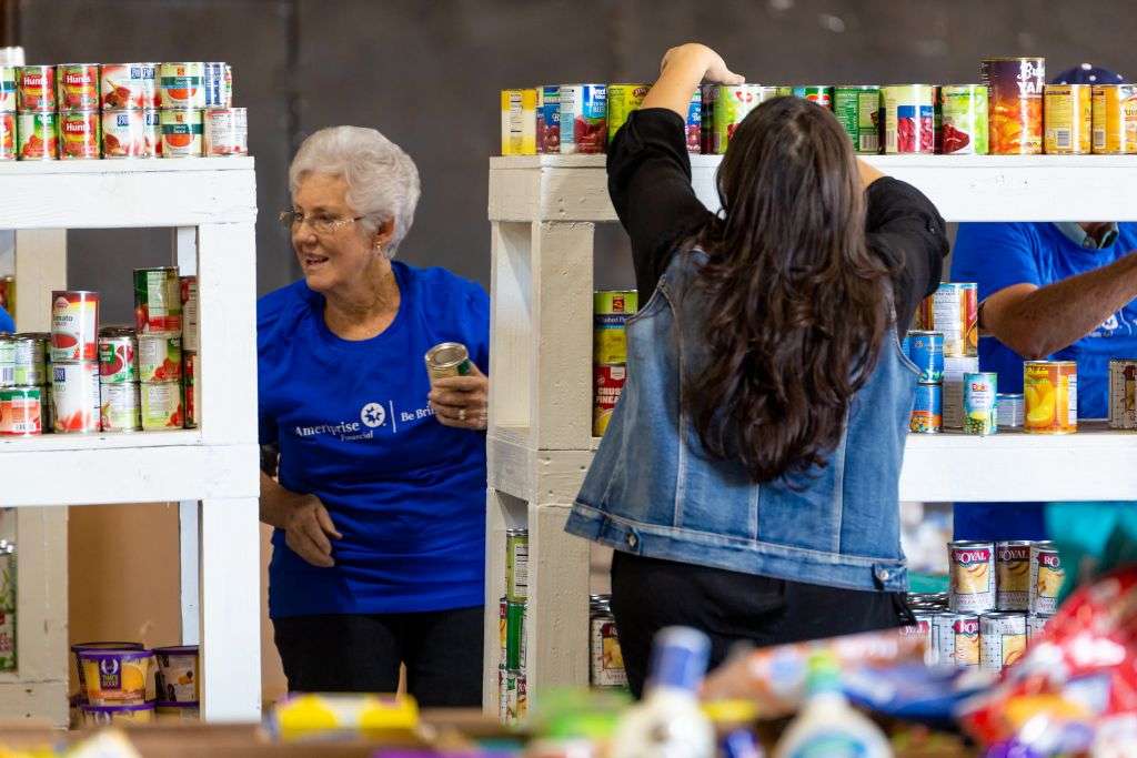 Two volunteers shelving canned goods at the MCFB warehouse