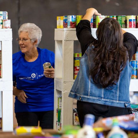 Two volunteers shelving canned goods at the MCFB warehouse