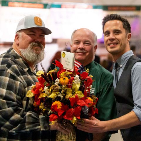 Rob Baptie, Bill Gibbs and Joe Hypes holding a beautiful flower arrangement