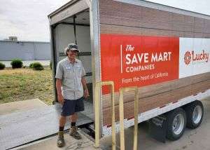 Tim standing in front of Save Mart truck for a food drive event