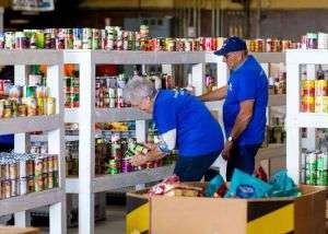 Volunteer workers sorting food at the Merced County Food Bank warehouse